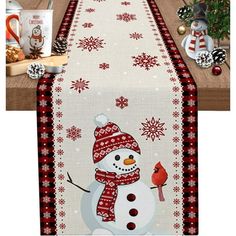 a christmas table runner with a snowman on it