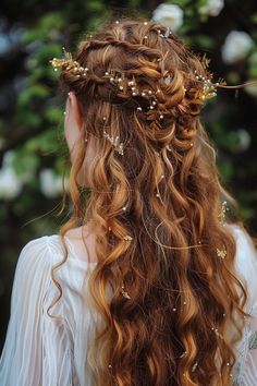 a woman with long red hair wearing a gold headpiece and flowers in her hair