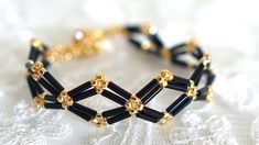 black and gold beaded bracelet on white lace