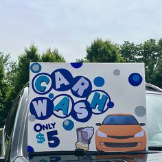 a car wash sign sitting on the back of a truck