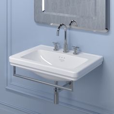 a bathroom sink sitting under a mirror in front of a wall mounted faucet