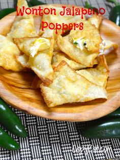 wonton jalapeno poppers on a wooden plate