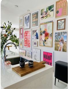 a kitchen counter with pictures on the wall