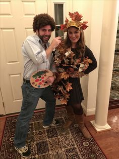 a man standing next to a woman holding a palette