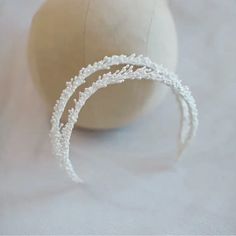 two white headbands sitting on top of a ball