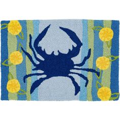 a blue crab door mat with yellow flowers on the bottom and green stripes in the background