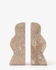 two pieces of stone sitting side by side on top of each other in front of a white background