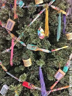 a christmas tree decorated with books and tassels