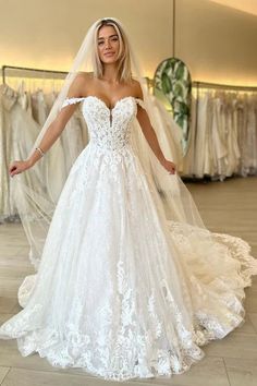 a woman in a white wedding dress posing for the camera with her arms spread out