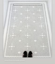 a person standing in front of a white rug