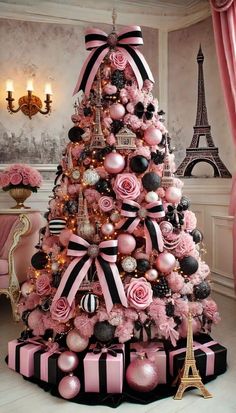 a pink and black christmas tree decorated with ornaments