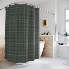 a bathroom with a bathtub, sink and shower curtain that has a plaid pattern on it