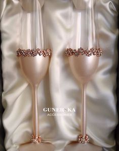 two champagne flutes with pink and gold glitters on them in a gift box for someone special occasion