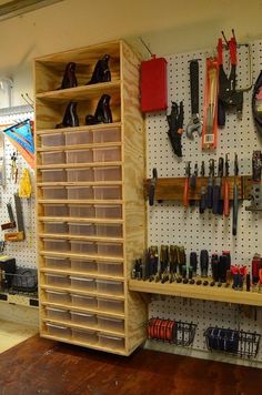 a room with several shelves and various tools on the wall, including pegboard shelving