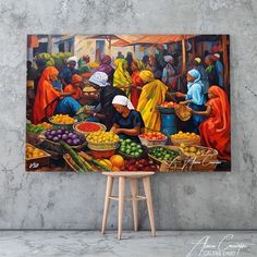 the painting is hanging on the wall next to a stool and table with fruit in it