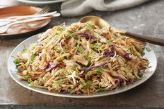 a white plate topped with shredded chicken and vegetables