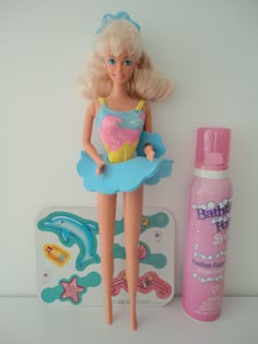 a barbie doll next to a bottle of toothpaste