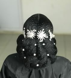 the back of a woman's head with flowers on it