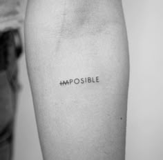 a person with a tattoo that says impossible