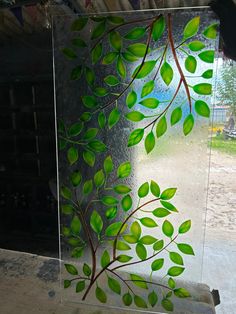 a glass block with green leaves painted on it