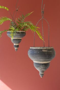 two hanging planters with plants in them