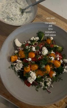 a salad with tomatoes, feta cheese and herbs