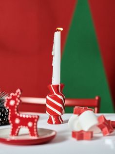 a white table topped with red and white christmas decorations