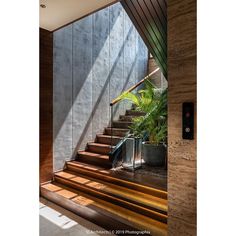 the stairs lead up to the second floor in this modern house with wood and concrete