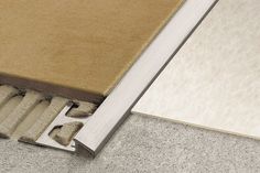 an open book laying on the floor next to a carpeted area with white and brown rugs