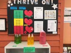 there are three bottles on the table and one is labeled with hearts, stars, and numbers