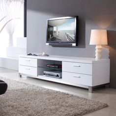 a living room scene with focus on the entertainment center and large screen tv in the corner