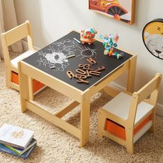 a child's wooden table and chair set up in a playroom with toys on the floor