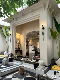 an outdoor area with tables, chairs and potted plants