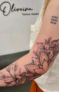 a woman's arm with a flower tattoo on the left side of her arm