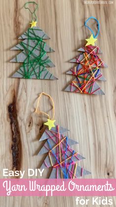 three christmas trees made out of yarn and string on a wooden table with text overlay that says easy diy yarn wrapped ornaments for kids