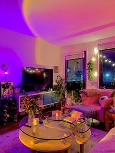 a living room filled with furniture and purple lighting