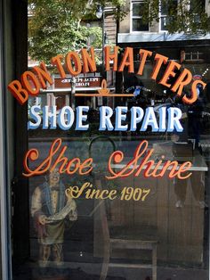 a shoe repair shop sign in the window