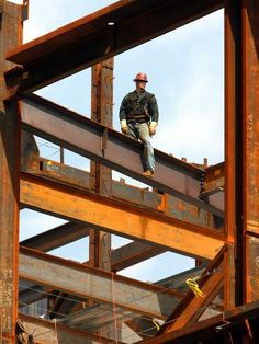 a man standing on top of a metal structure