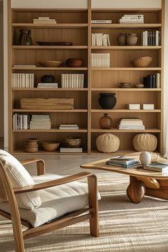 a living room filled with furniture and bookshelves next to a wall full of shelves