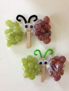 grapes and grapes are wrapped in plastic bags with eyes on them, as if they were made to look like butterflies