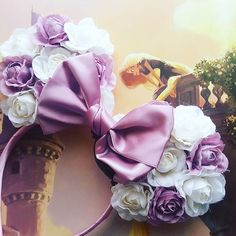 a purple and white flowered headband on top of a wall