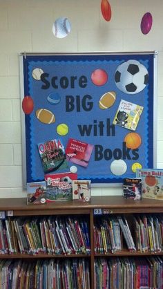 a book shelf filled with lots of books next to a soccer ball on the wall