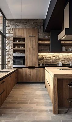 a modern kitchen with stone walls and flooring is pictured in this image, there are wooden cabinets on either side of the counter