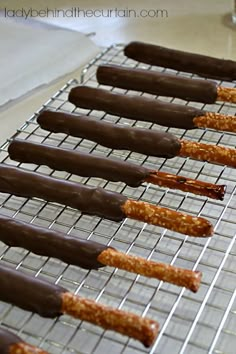 chocolate covered pretzels are lined up on a cooling rack and ready to be eaten