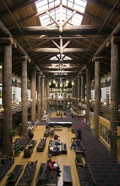 the inside of a large building with lots of tables and couches on each floor