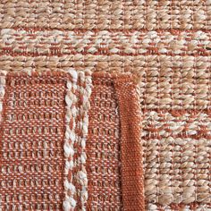 close up view of woven fabric with orange and white stripes