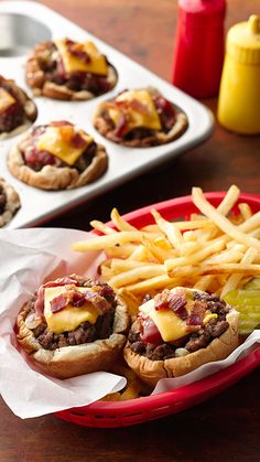 mini burgers and fries are sitting on a table