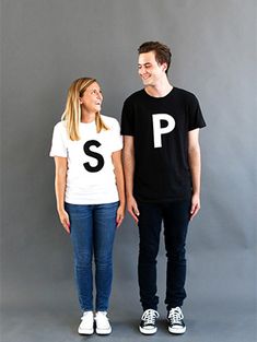 a man and woman standing next to each other with the letter p on their t - shirts