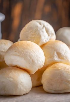 a pile of bread rolls sitting on top of a table