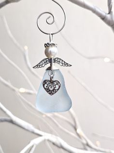 a glass bell ornament hanging from a tree